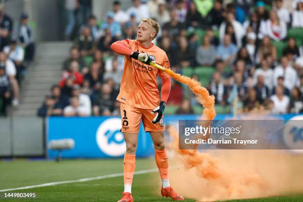 Tom Glover of Melbourne City picks up a flare to remove it from the pitch during the round eight A-League Men's match between Melbourne City and...