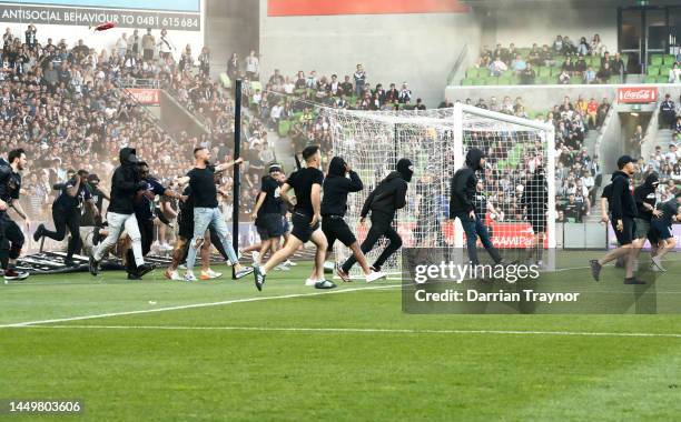 Fans storm the pitch in protest during the round eight A-League Men's match between Melbourne City and Melbourne Victory at AAMI Park, on December 17...