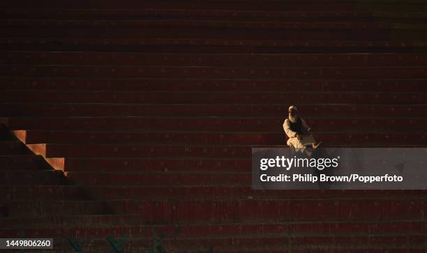 Lone man watches from a stand during the first day of the third Test between Pakistan and England at Karachi National Stadium on December 17, 2022 in...