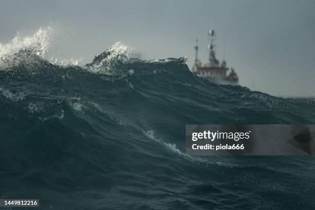 fishing boat trawler sailing out at rough sea - slow motion water stock pictures, royalty-free photos & images