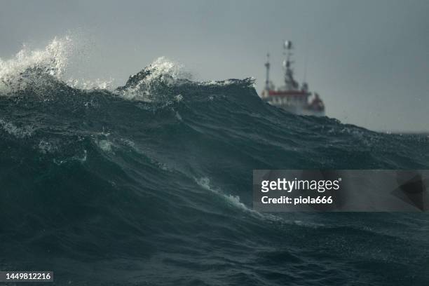 fishing boat trawler sailing out at rough sea - trålare bildbanksfoton och bilder