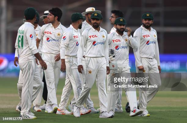 Babar Azam of Pakistan leads his team off at the close of play during day one of the Third Test match between Pakistan and England at Karachi...
