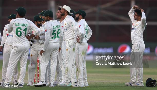 Abrar Ahmed of Pakistan waits with his team, as they review a decision during day one of the Third Test match between Pakistan and England at Karachi...