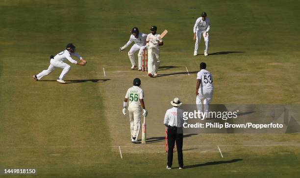 Ollie Pope of England dives forward to catch Saud Shakeel of Pakistan off the bowling of Rehan Ahmed on the first day of the third Test between...