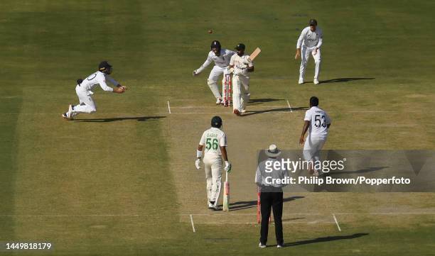 Ollie Pope of England moves forward to catch Saud Shakeel of Pakistan off the bowling of Rehan Ahmed on the first day of the third Test between...