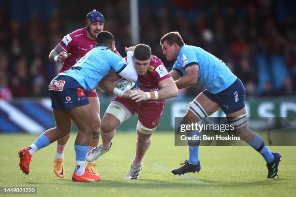 Dave Ewers of Exeter is tackled by Stravino Jacobs and Muller Uys of Vodacom during the Heineken Champions Cup Pool A match between Exeter Chiefs and...