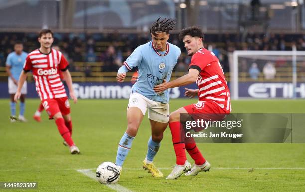 Rico Lewis of Manchester City battles for possession with Miguel Gutierrez of Girona FC during the friendly match between Manchester City and Girona...