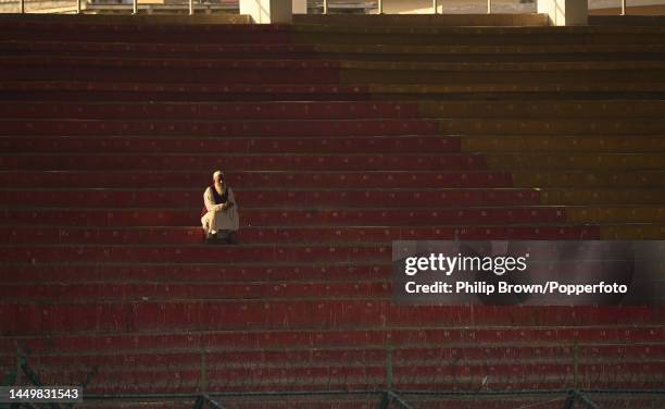 Lone man watches from a stand during the first day of the third Test between Pakistan and England at Karachi National Stadium on December 17, 2022 in...