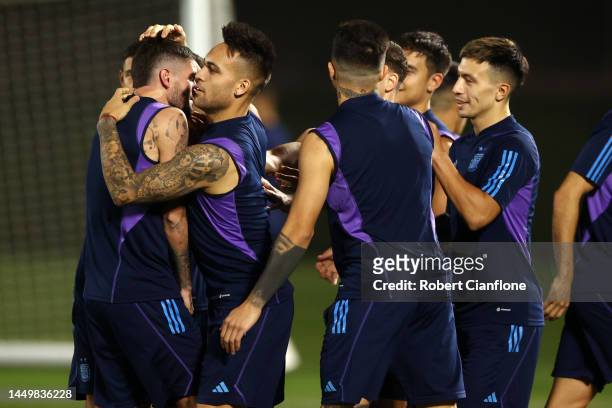 Rodrigo De Paul of Argentina interacts with teammate Lautaro Martinez during the Argentina Training Session ahead of their World Cup Final match...