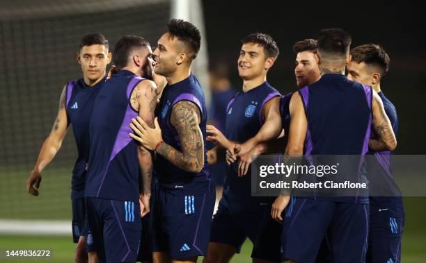 Rodrigo De Paul of Argentina interacts with teammate Lautaro Martinez during the Argentina Training Session ahead of their World Cup Final match...