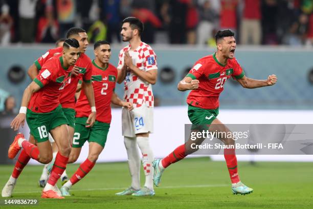 Achraf Dari of Morocco celebrates with teammates after scoring the team's first goal during the FIFA World Cup Qatar 2022 3rd Place match between...