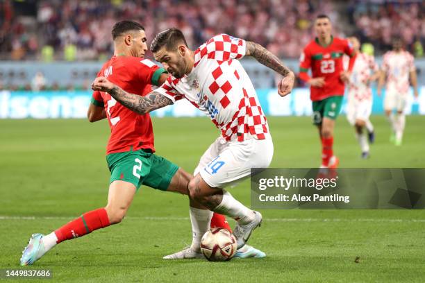 Achraf Hakimi of Morocco battles for possession with Marko Livaja of Croatia during the FIFA World Cup Qatar 2022 3rd Place match between Croatia and...