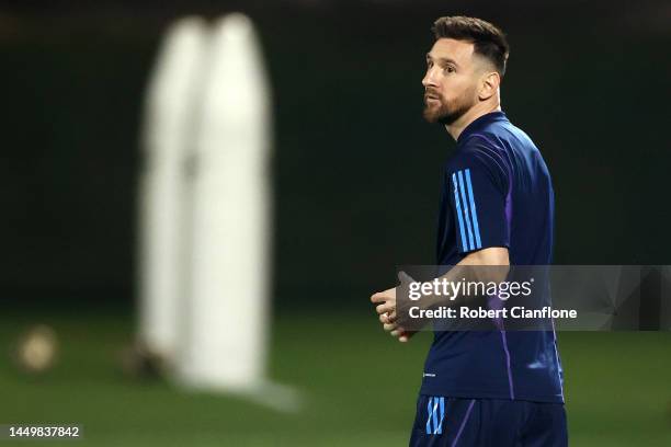 Lionel Messi of Argentina looks on during the Argentina Training Session ahead of their World Cup Final match against France at Qatar University...