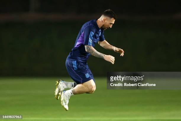 Lionel Messi of Argentina warms up during the Argentina Training Session ahead of their World Cup Final match against France at Qatar University...