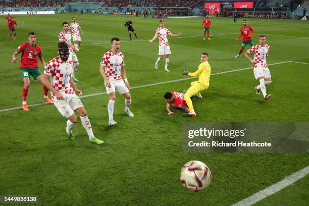 Achraf Dari of Morocco scores the team's first goal past Dominik Livakovic of Croatia during the FIFA World Cup Qatar 2022 3rd Place match between...