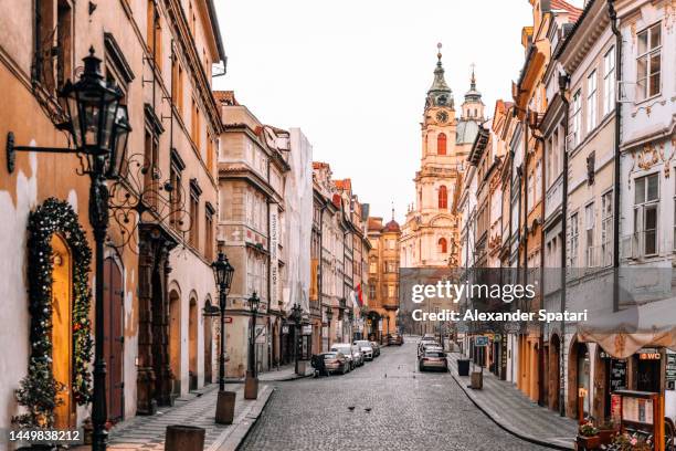 mala strana and empty nerudova street in the morning, prague, czech republic - oost europese cultuur stockfoto's en -beelden