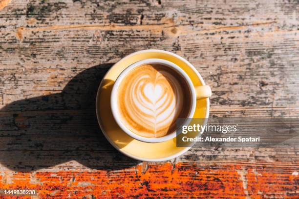 cup of cappuccino with heart shaped latte art, directly above view - bohemia czech republic stock-fotos und bilder