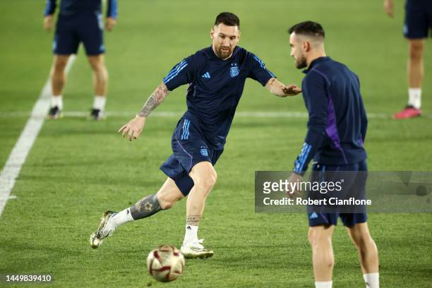 Lionel Messi of Argentina trains with teammates during the Argentina Training Session ahead of their World Cup Final match against France at Qatar...