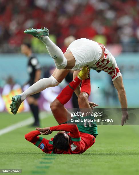 Sofiane Boufal of Morocco and Josip Sutalo of Croatia collide during the FIFA World Cup Qatar 2022 3rd Place match between Croatia and Morocco at...