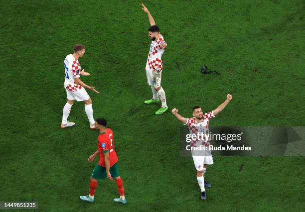 Kristijan Jakic, Josko Gvardiol and Mateo Kovacic of Croatia celebrate the team's 2-1 victory in the FIFA World Cup Qatar 2022 3rd Place match...