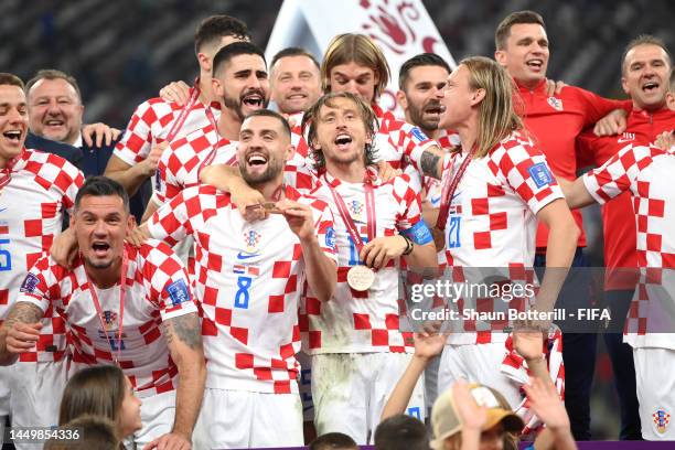 Luka Modric of Croatia and teammates celebrate with the FIFA World Cup Qatar 2022 third placed medals after the team's victory during the FIFA World...