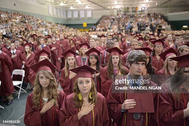 Gradutates listen to then national anthem during the Joplin High School Commencement Ceremony May 21, 2012 at Missouri Southern State University in...
