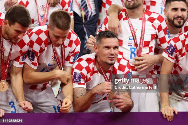 Dejan Lovren of Croatia and teammates celebrate with their FIFA World Cup Qatar 2022 third placed medals after the team's victory during the FIFA...