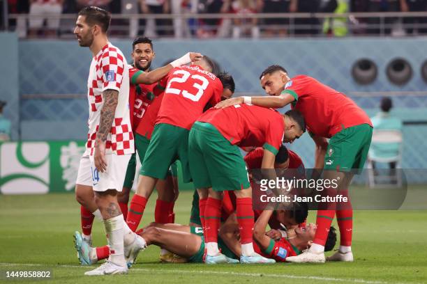 Achraf Dari of Morocco celebrates after scoring his team's first goal with team mates during the FIFA World Cup Qatar 2022 3rd Place match between...
