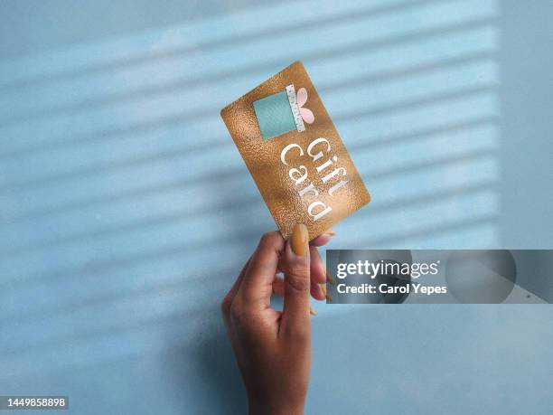 female hand holding gift hand - voucher card imagens e fotografias de stock