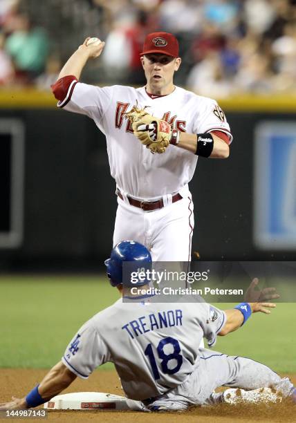 Infielder Aaron Hill of the Arizona Diamondbacks throws over the sliding Matt Treanor of the Los Angeles Dodgers as he attempts an unsuccessful...