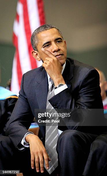 President Barack Obama listens to Missouri Gov. Jay Nixon give a speech during the Joplin High School Commencement Ceremony for the Class of 2012 at...