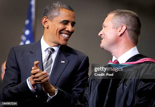 President Barack Obama shares a laugh with Joplin Schools Superintendent Doctor C.J. Huff after Huff's speech during the Joplin High School...