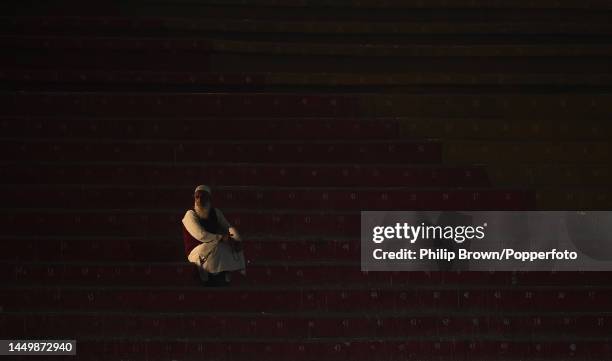 Lone man watches from a stand during the first day of the third Test between Pakistan and England at Karachi National Stadium on December 17, 2022 in...