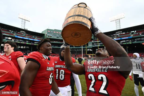 Linebacker Yasir Abdullah of the Louisville Cardinals holds up the Keg of Nails Trophy after the Cardinals defeated the Cincinnati Bearcats in Wasabi...