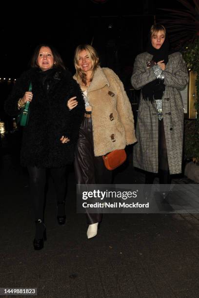 Sienna Miller and Fran Cutler leaving The Aubrey Restaurant in Knightsbridge on December 17, 2022 in London, England.