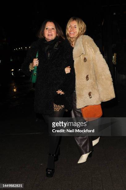 Sienna Miller and Fran Cutler leaving The Aubrey Restaurant in Knightsbridge on December 17, 2022 in London, England.