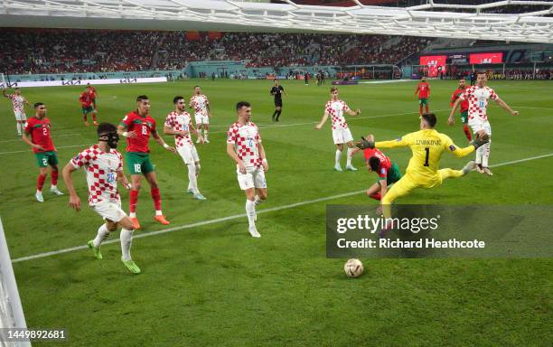 Achraf Dari of Morocco scores his team's first goal during the FIFA World Cup Qatar 2022 3rd Place match between Croatia and Morocco at Khalifa...