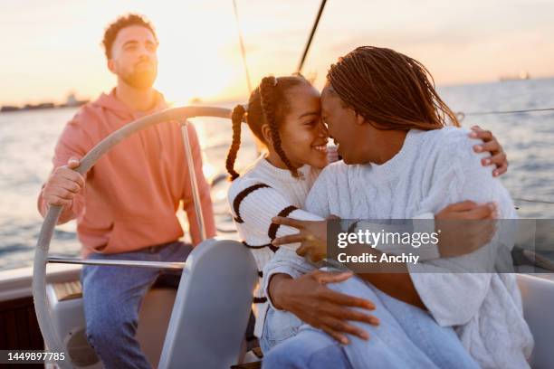 family yacht sailing in the sunset - luxury boat stockfoto's en -beelden