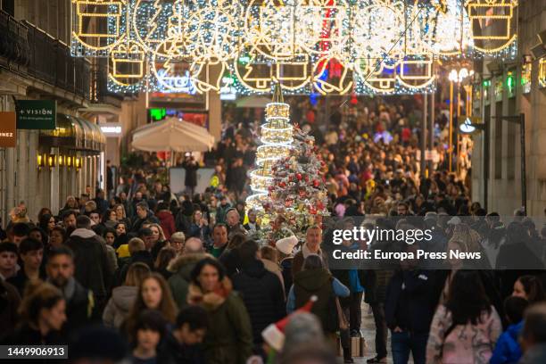 Several people walk through the center of the city of Vigo to enjoy the Christmas illumination, on 17 December, 2022 in Vigo, Pontevedra, Galicia,...