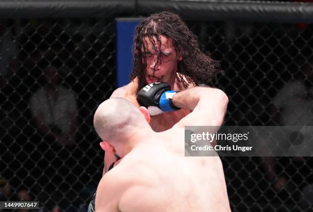 Rinat Fakhretdinov of Russia punches Bryan Battle in a welterweight fight during the UFC Fight Night event at UFC APEX on December 17, 2022 in Las...