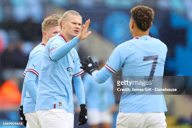 Erling Haaland of Manchester City acknowledges Morgan Rogers after Kevin De Bruyne scores his side's first goal during the friendly match between...