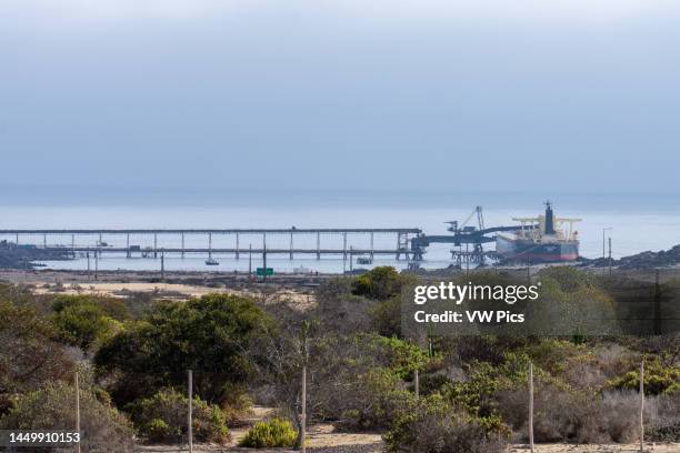 Bulk freighter ship at the Pacific Mining Company's Puerto Punta Totoralillo iron ore loading facility near Caldera, Chile.