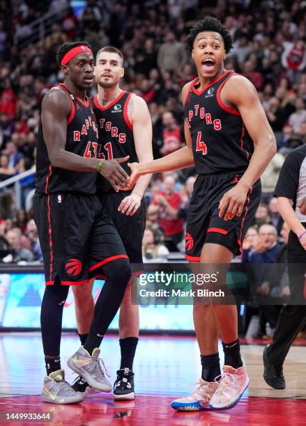 Scottie Barnes, Pascal Siakam, and Juancho Hernangomez of the Toronto Raptors against the Brooklyn Nets during the second half of their basketball...