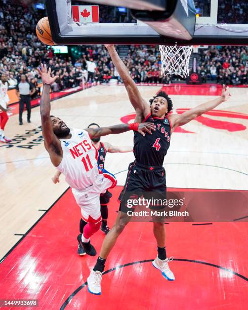 Kyrie Irving of the Brooklyn Nets goes to the basket against Scottie Barnes of the Toronto Raptors during the second half of their basketball game at...