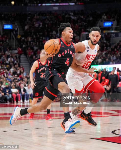 Scottie Barnes of the Toronto Raptors drives against Ben Simmons of the Brooklyn Nets during the second half of their basketball game at the...