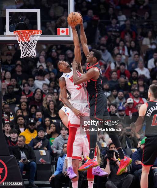 Nicolas Claxton of the Brooklyn Nets blocks Christian Koloko of the Toronto Raptors during the first half of their basketball game at the Scotiabank...