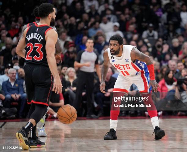 Fred VanVleet of the Toronto Raptors is guarded by Kyrie Irving of the Brooklyn Nets during the first half of their basketball game at the Scotiabank...