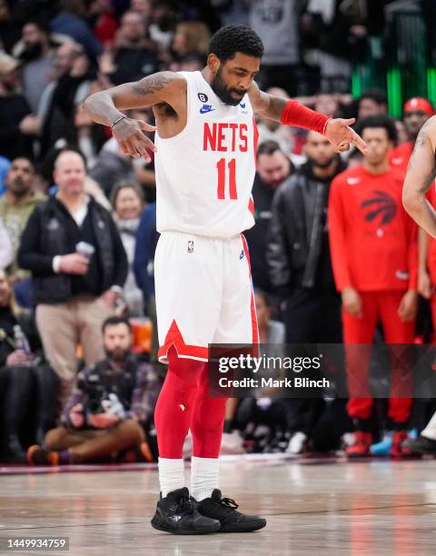 Kyrie Irving of the Brooklyn Nets celebrates his game winning buzzer beater shot against the Toronto Raptors during the second half of their...