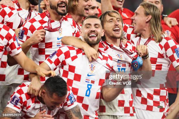 Luka Modric of Croatia and his teammates celebrate with their bronze third place medals during the FIFA World Cup Qatar 2022 3rd Place match between...