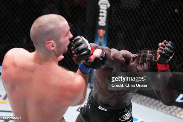Jared Cannonier punches Sean Strickland in a middleweight fight during the UFC Fight Night event at UFC APEX on December 17, 2022 in Las Vegas,...